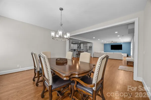 a view of a dining room with furniture wooden floor and chandelier