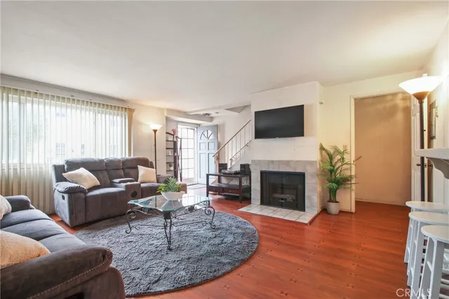 a living room with furniture a fireplace and a flat screen tv
