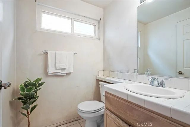 a bathroom with a sink toilet and a mirror