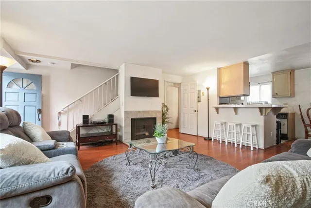 a living room with furniture fireplace and a window