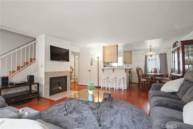 a living room with furniture a fireplace and a flat screen tv