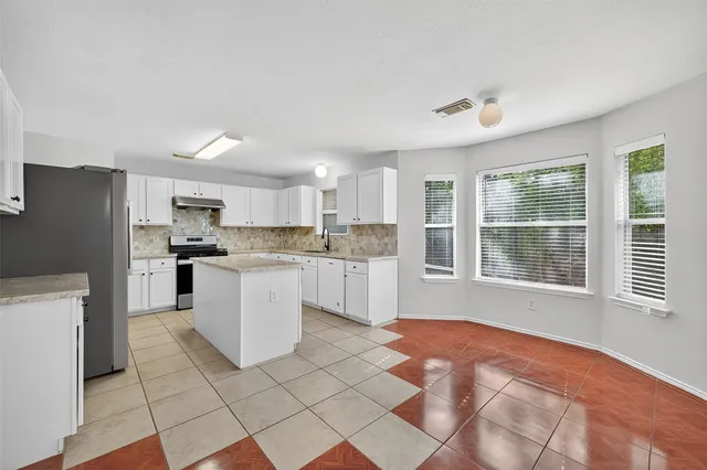 a kitchen with a stove a sink and a refrigerator