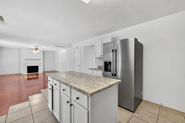 a kitchen with a sink refrigerator and microwave