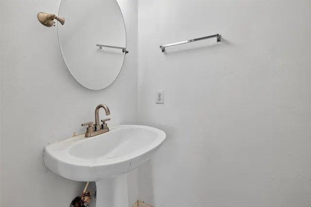 a bathroom with a sink a mirror and a toilet