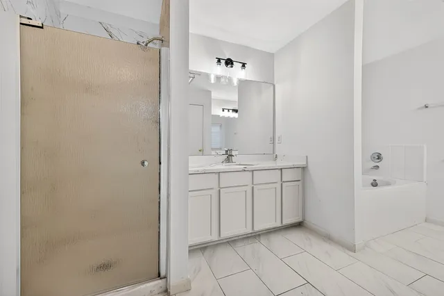 a bathroom with a double vanity sink mirror and shower