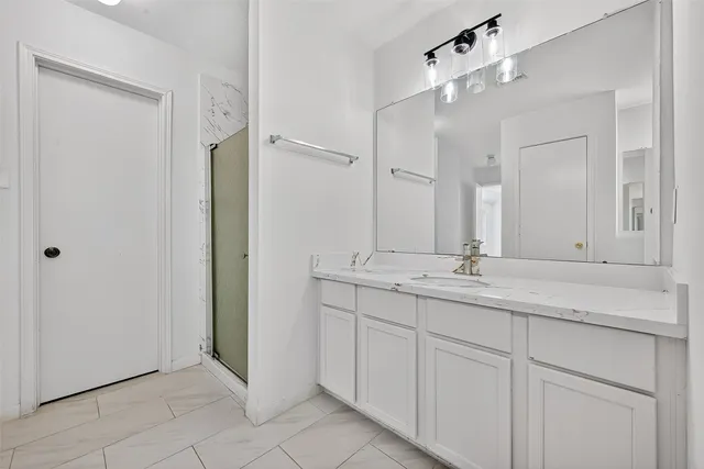 a bathroom with a double vanity sink and mirror