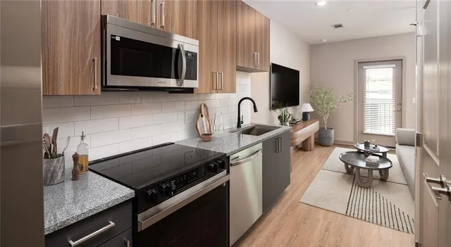 a kitchen with a stove a sink and a microwave