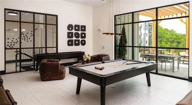 a dining room with furniture and a large window