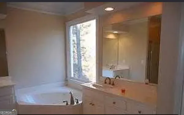 a bathroom with bathtub and window