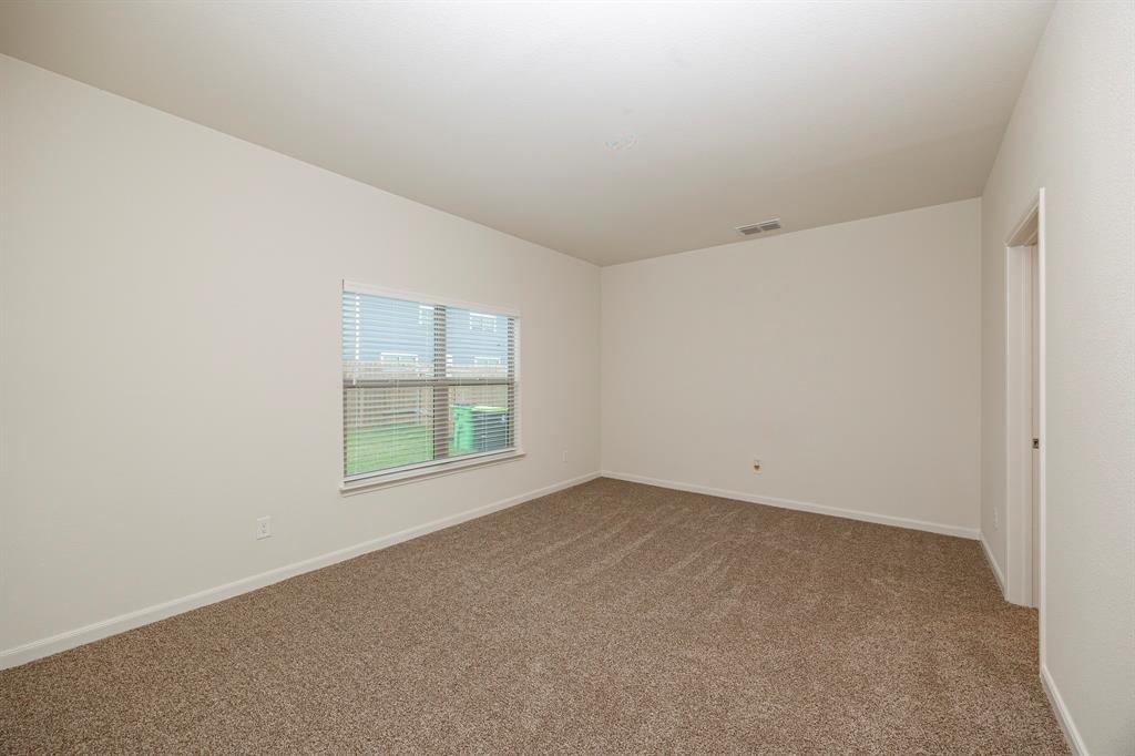 13608 Mineral Road Ponder, TX 76259 - Photo 12 of 36 Carpeted spare room featuring baseboards