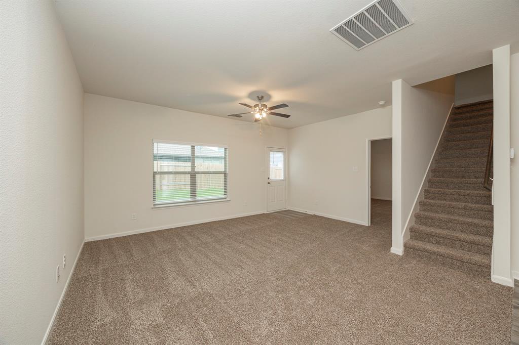 13608 Mineral Road Ponder, TX 76259 - Photo 18 of 36 Unfurnished room featuring carpet floors, stairs, and ceiling fan
