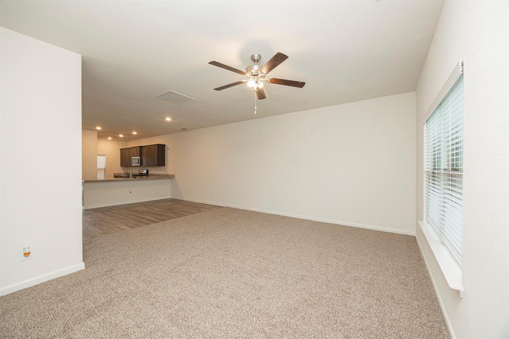 13608 Mineral Road Ponder, TX 76259 - Photo 19 of 36 Unfurnished living room with carpet floors, ceiling fan, and recessed lighting