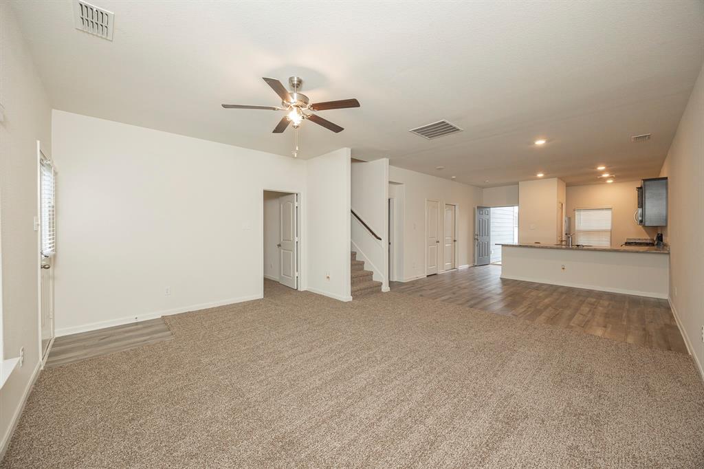 13608 Mineral Road Ponder, TX 76259 - Photo 20 of 36 Unfurnished living room featuring carpet, a ceiling fan, stairs, and recessed lighting