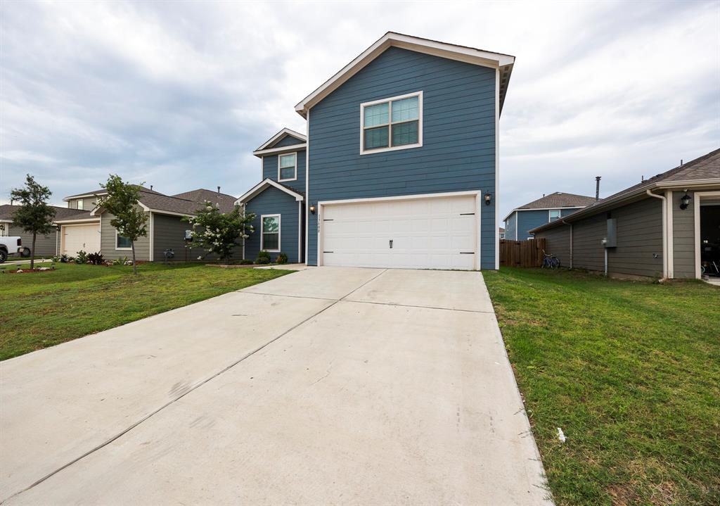 13608 Mineral Road Ponder, TX 76259 - Photo 2 of 36 Traditional home featuring concrete driveway, an attached garage, and a front yard