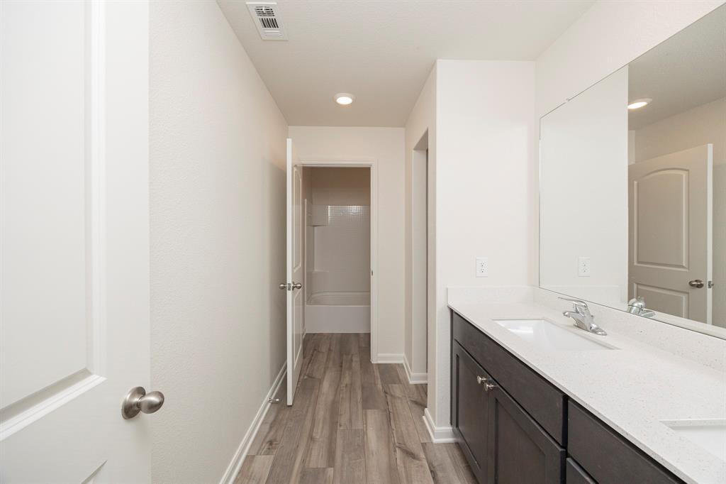 13608 Mineral Road Ponder, TX 76259 - Photo 25 of 36 Full bathroom with double vanity, wood finished floors, a bath, and recessed lighting