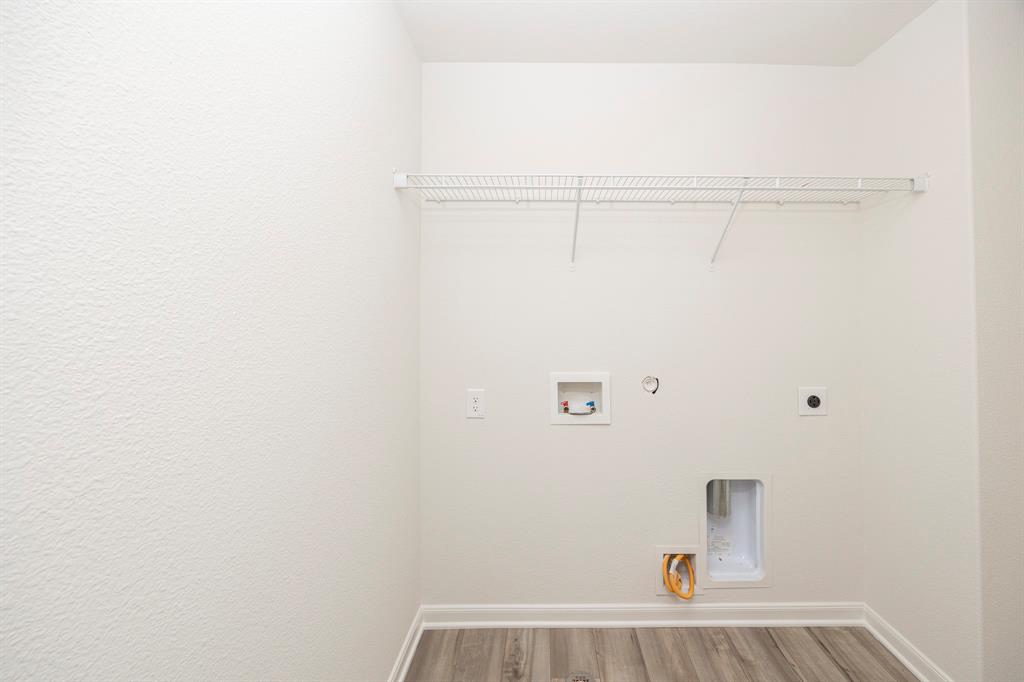 13608 Mineral Road Ponder, TX 76259 - Photo 26 of 36 Laundry room featuring hookup for an electric dryer, wood finished floors, gas dryer hookup, and washer hookup