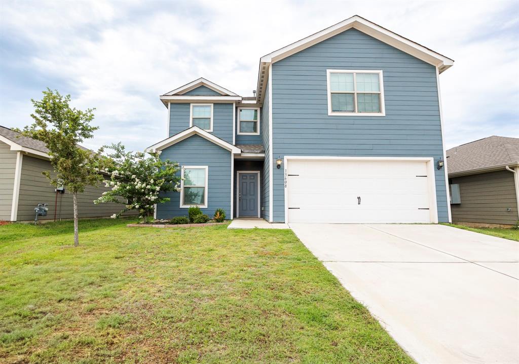 13608 Mineral Road Ponder, TX 76259 - Photo 4 of 36 Traditional-style home with an attached garage, concrete driveway, and a front lawn
