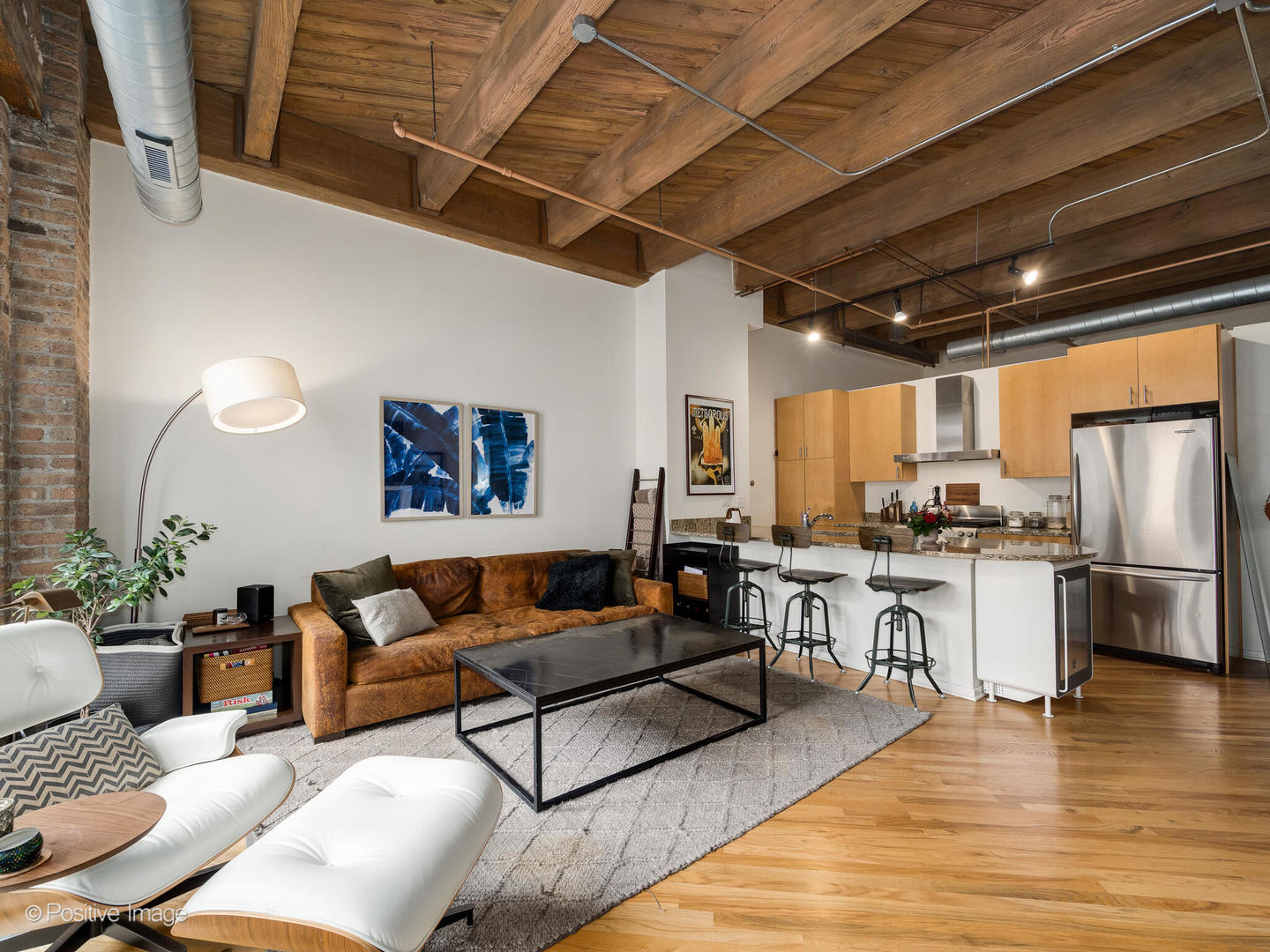 1040 West Adams Street, Unit 350 Chicago, IL 60607 - Photo 5 of 22 a living room with furniture and kitchen view