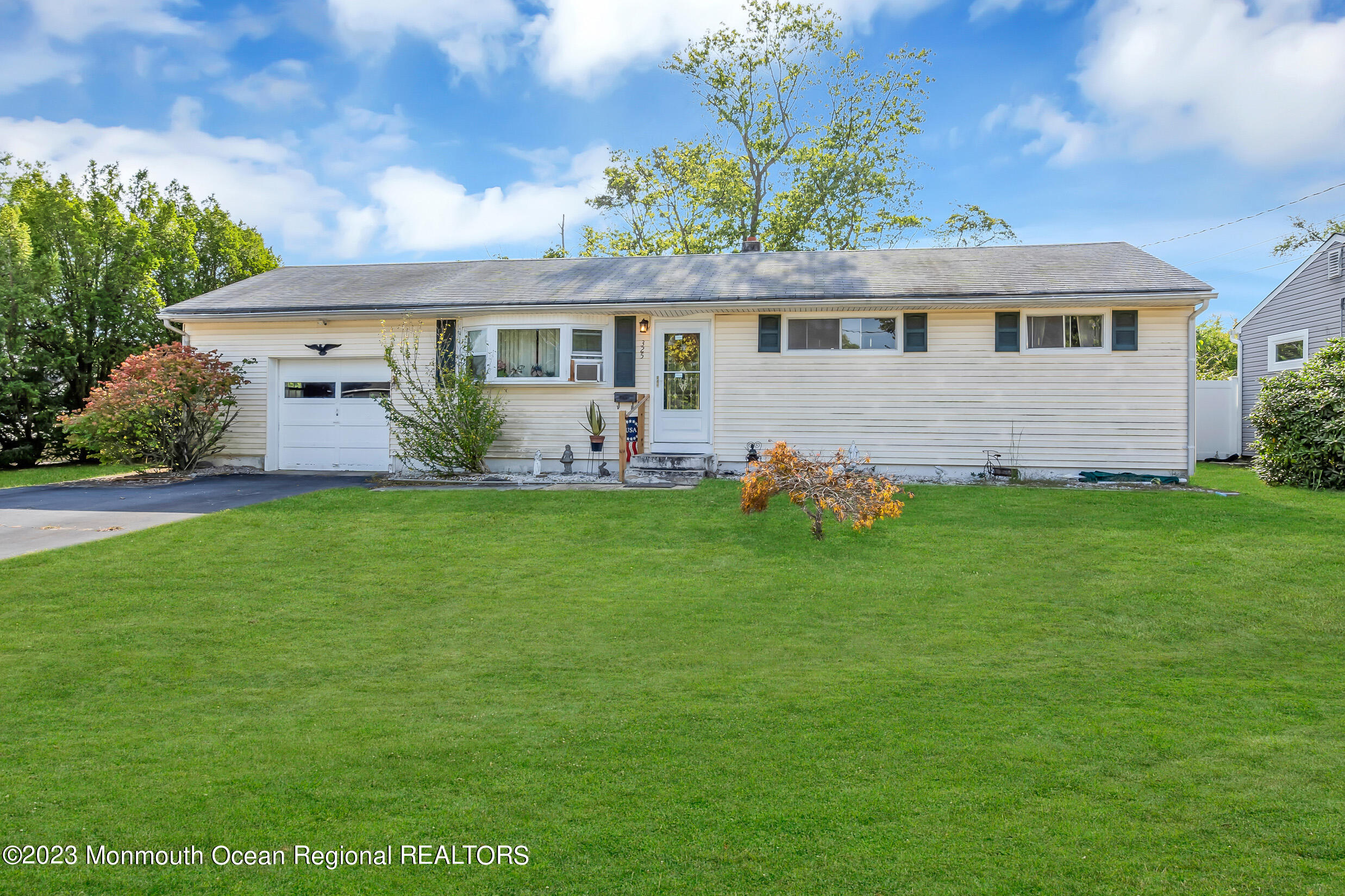 325 Stearman Road Brick, NJ 08723 - Photo 4 of 35 a front view of house with yard and outdoor seating