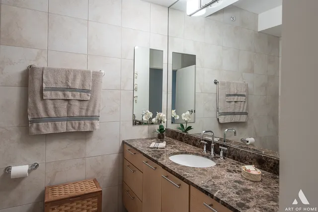 a bathroom with a granite countertop sink and a mirror