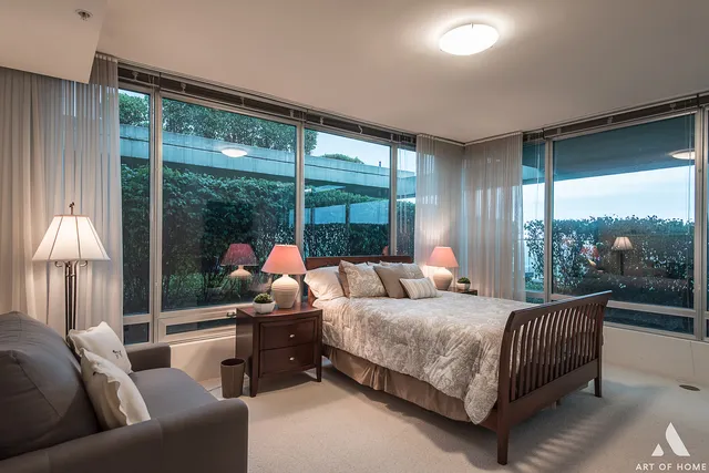 a bedroom with a bed and glass window