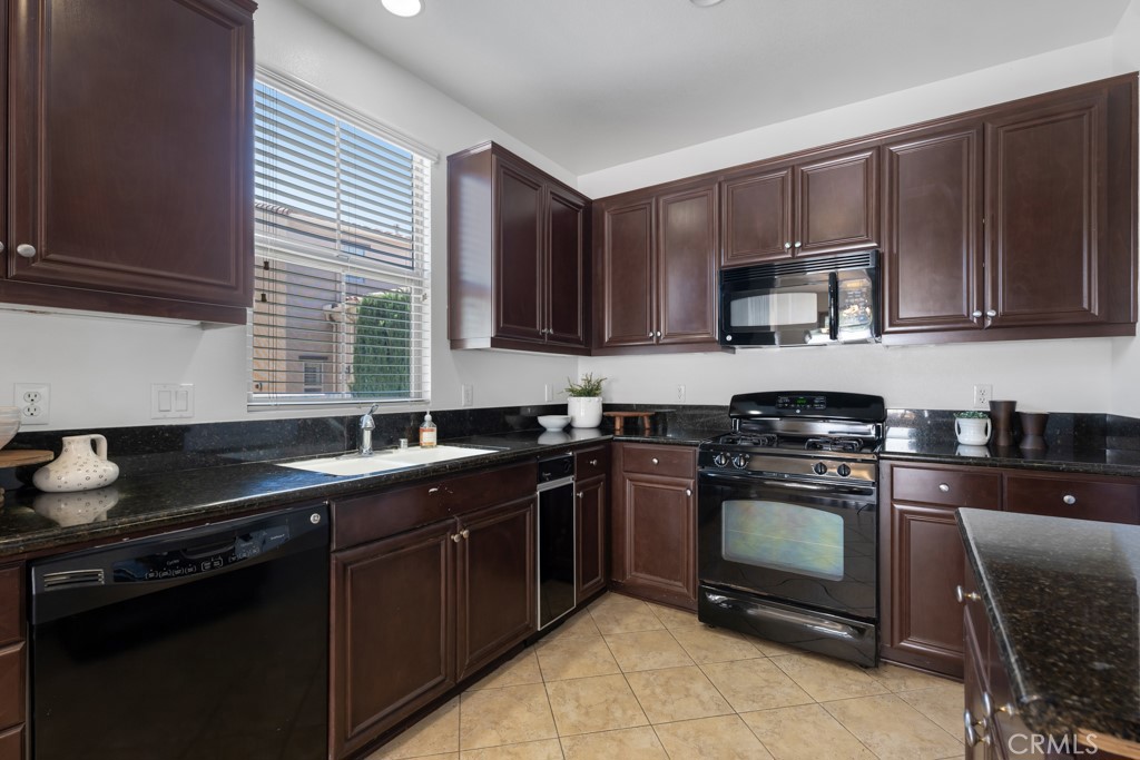 20317 Livorno Porter Ranch Porter Ranch, CA 91326 - Photo 4 of 33 a kitchen with a sink stove top oven and cabinets