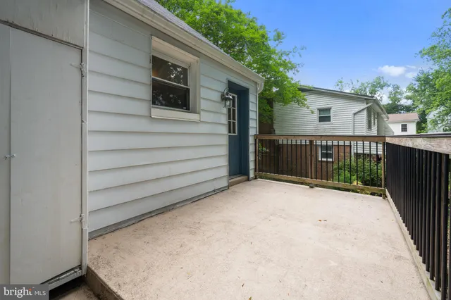 a view of a house with a wooden fence