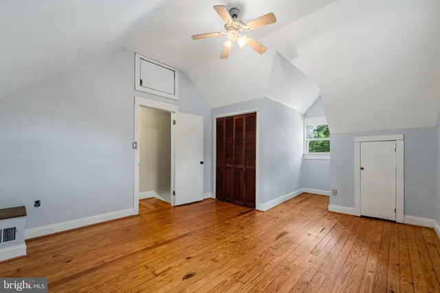 a view of a big room with wooden floor and windows in a room
