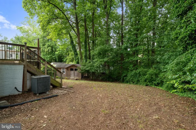 a pathway of a house with large trees