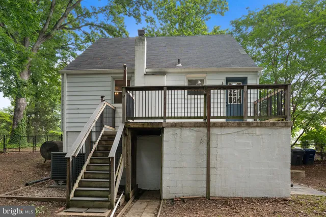 a view of a house with deck and a couple