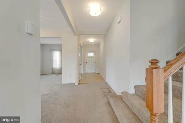 a view of a livingroom with wooden floor and stairs