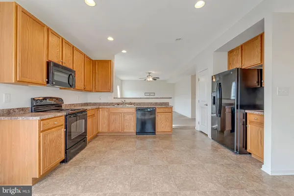 a kitchen with stainless steel appliances granite countertop a refrigerator sink and cabinets