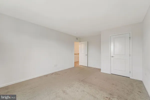 a view of an empty room and closet area