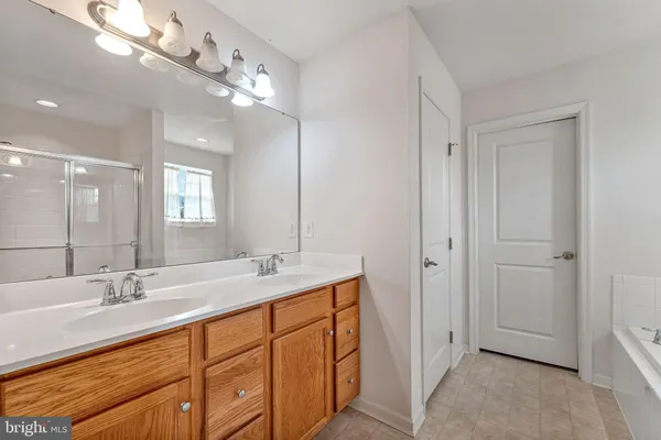 a bathroom with a double vanity sink and a mirror