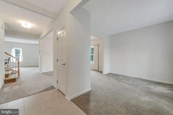 an empty room with windows and entrance