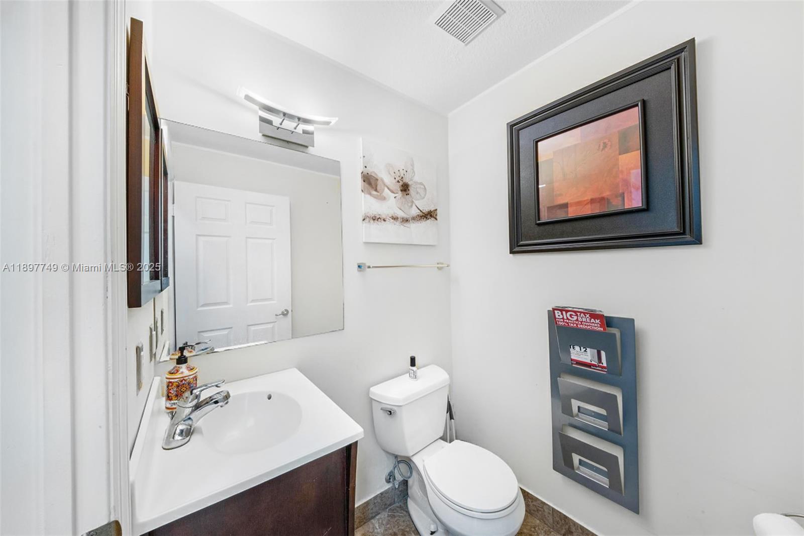 3869 Northwest 92nd Avenue Sunrise, FL 33351 - Photo 14 of 40 a bathroom with a toilet a sink and mirror