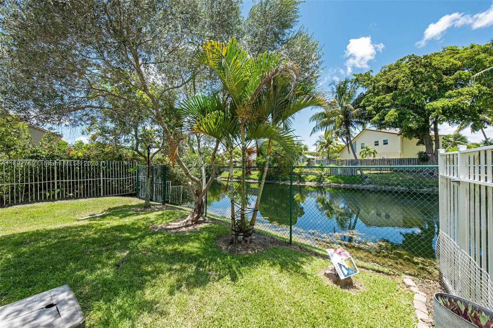 3869 Northwest 92nd Avenue Sunrise, FL 33351 - Photo 15 of 40 a view of a lake with a yard and large trees