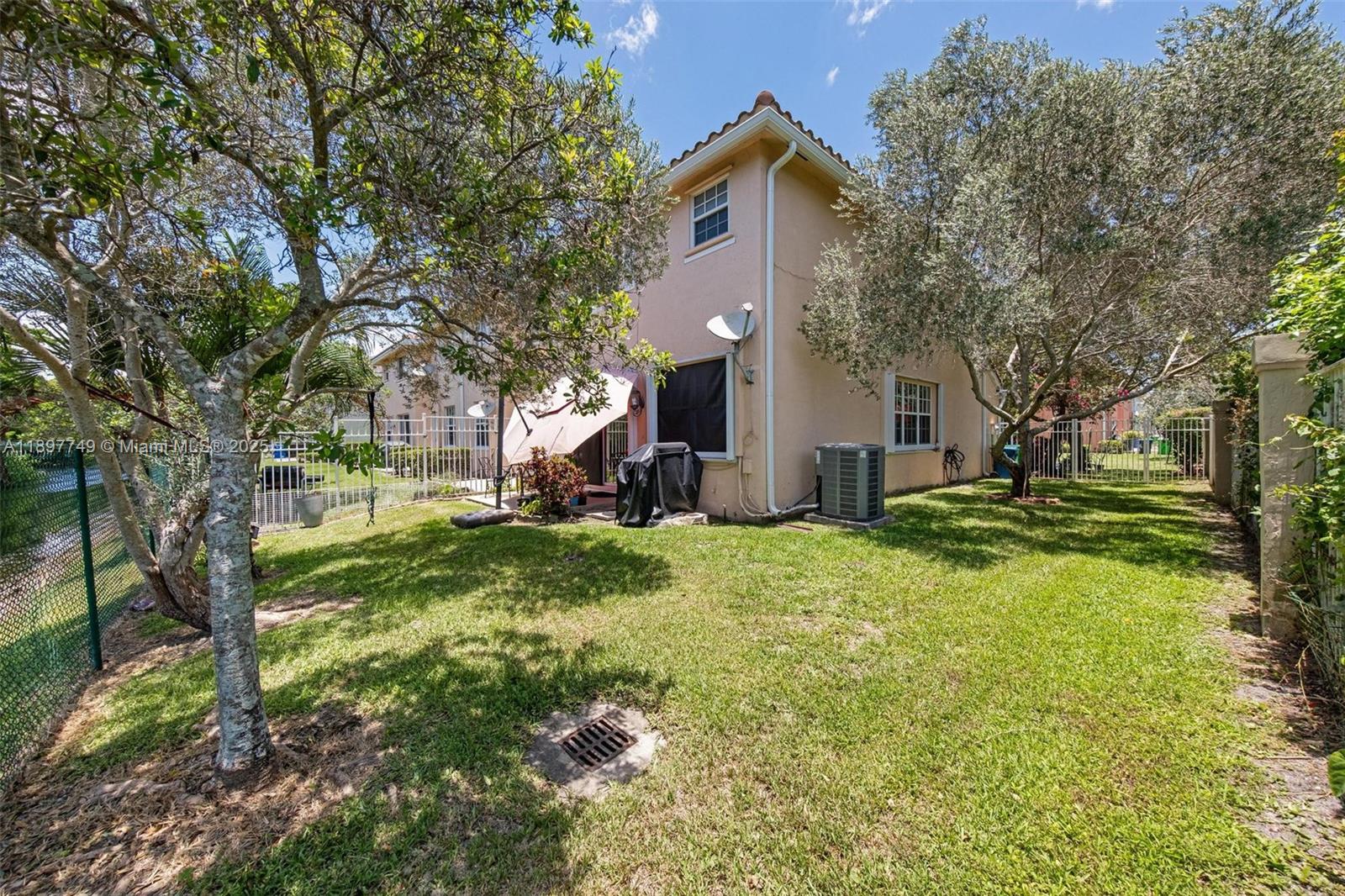 3869 Northwest 92nd Avenue Sunrise, FL 33351 - Photo 18 of 40 a front view of house with yard and green space