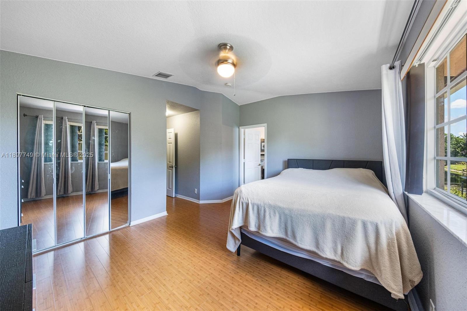 3869 Northwest 92nd Avenue Sunrise, FL 33351 - Photo 22 of 40 a bedroom with a bed and a chandelier