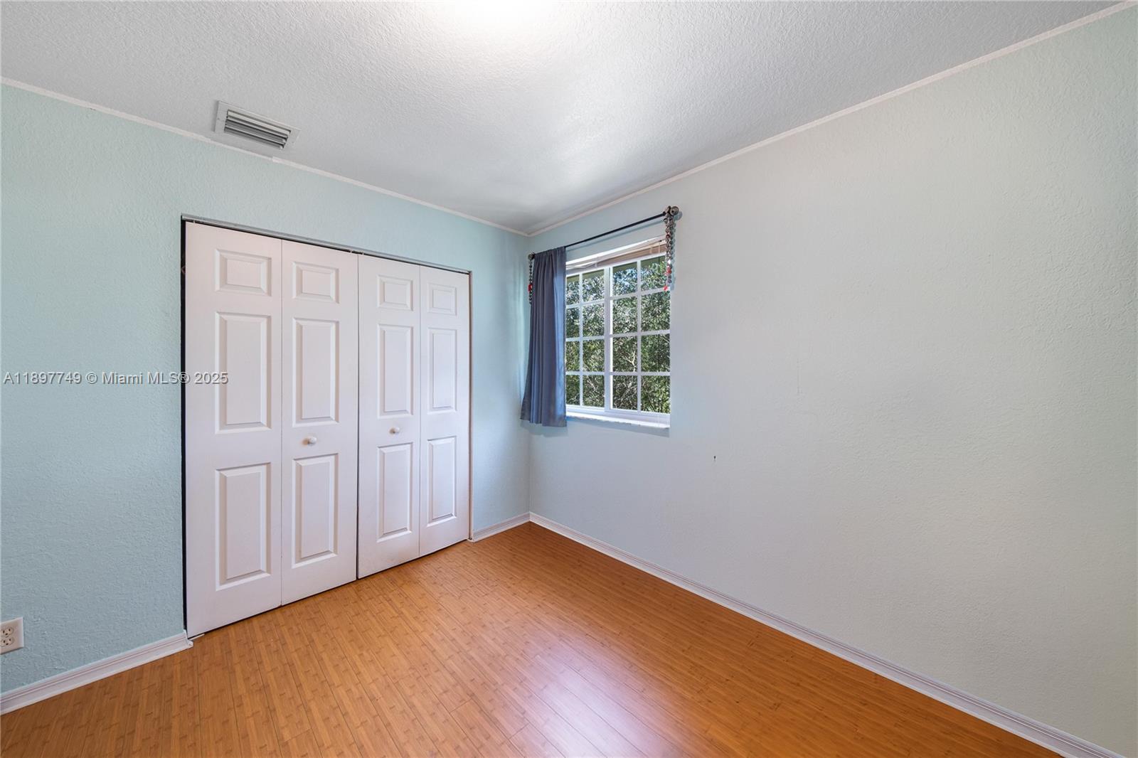 3869 Northwest 92nd Avenue Sunrise, FL 33351 - Photo 25 of 40 an empty room with wooden floor and windows