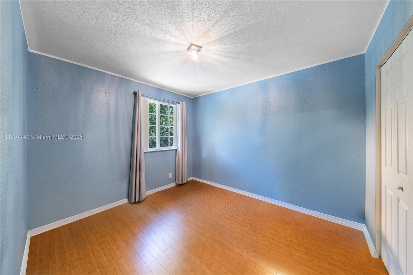 3869 Northwest 92nd Avenue Sunrise, FL 33351 - Photo 26 of 40 a view of a big room with windows and chandelier fan