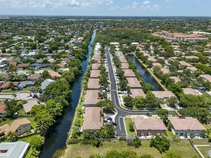 an aerial view of residential houses with outdoor space and river view
