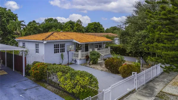 a view of a house with a yard and sitting area