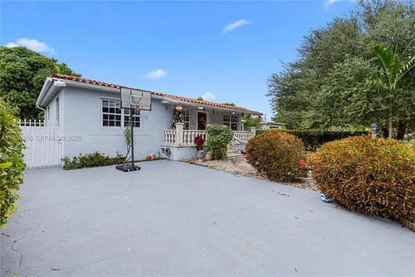 a view of a house with a yard and sitting area