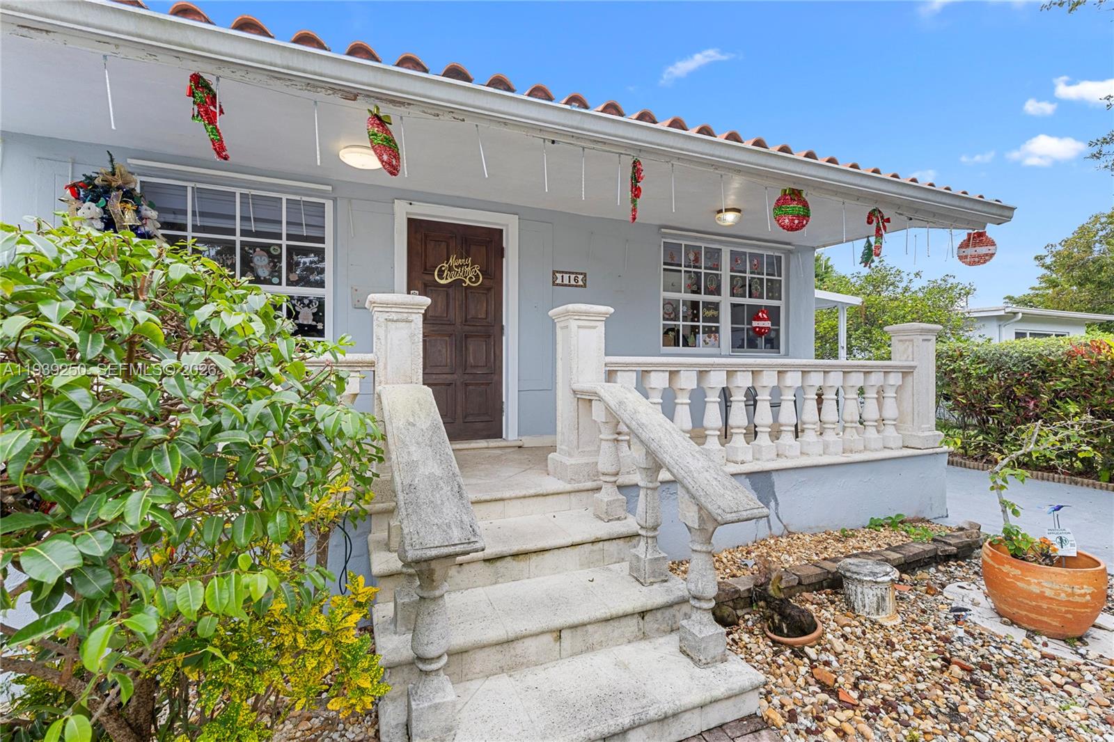 116 East 59th Street Hialeah, FL 33013 - Photo 26 of 51 a balcony with furniture and flowers