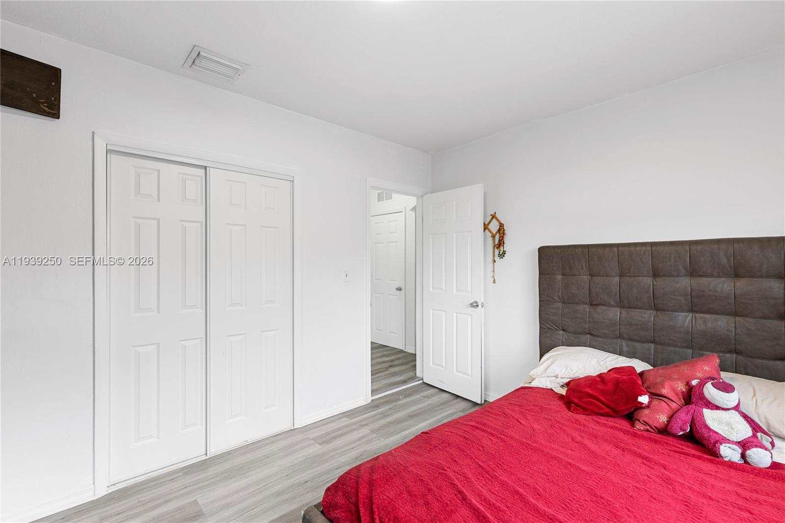 116 East 59th Street Hialeah, FL 33013 - Photo 28 of 51 a bedroom with a bed and a closet