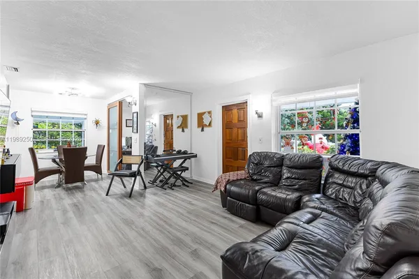 a kitchen with refrigerator and cabinets
