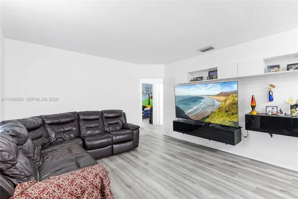 a kitchen with stainless steel appliances a stove a refrigerator and a wooden floor