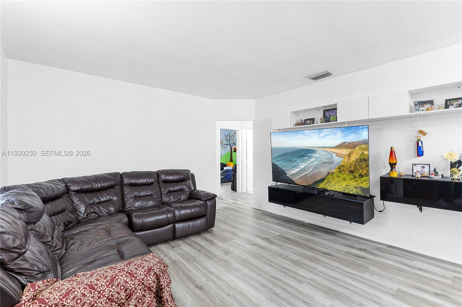 116 East 59th Street Hialeah, FL 33013 - Photo 35 of 51 a living room with furniture and a flat screen tv