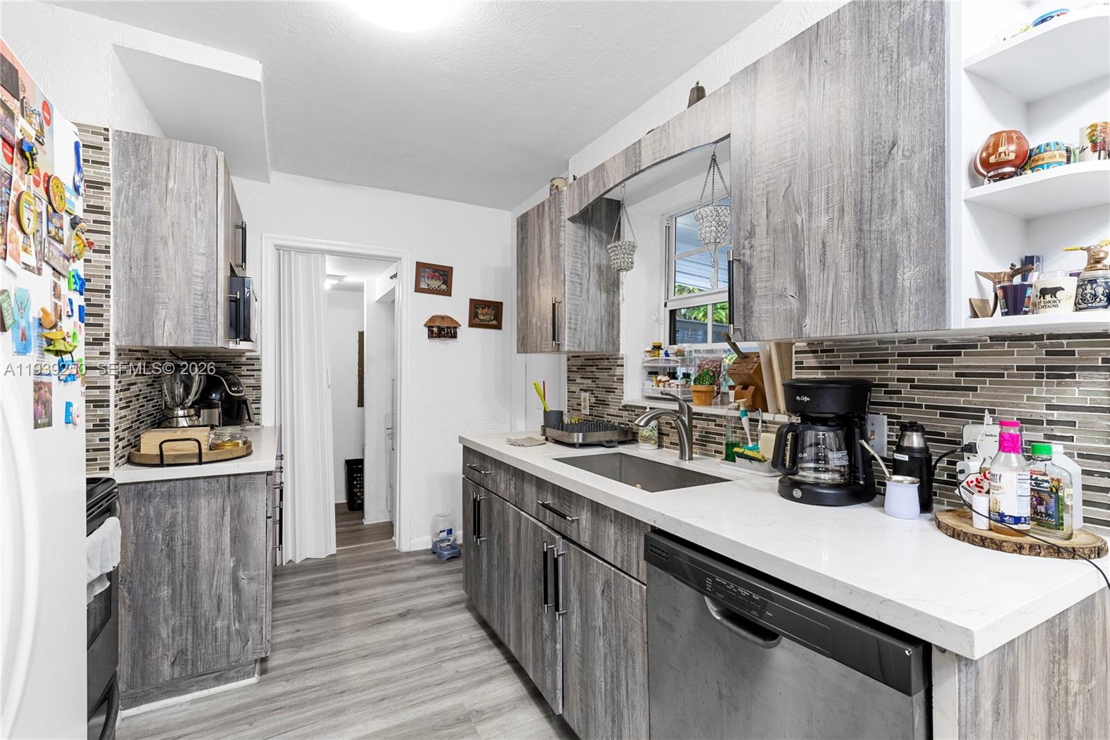 116 East 59th Street Hialeah, FL 33013 - Photo 36 of 51 a kitchen with refrigerator and cabinets